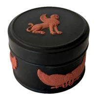Specifications Brand: Wedgwood Collection: Egyptian Collection Material: Jasperware (black with terracotta relief) Origin: England Year: 1979 Diameter: 1.625 in (4.1 cm) Height: 1.25 in (3.2 cm) Motif: Winged sphinx and Egyptian-style relief decoration Condition: Very good vintage condition. Minor surface wear consistent with age. Relief decoration remains sharp and well-defined.