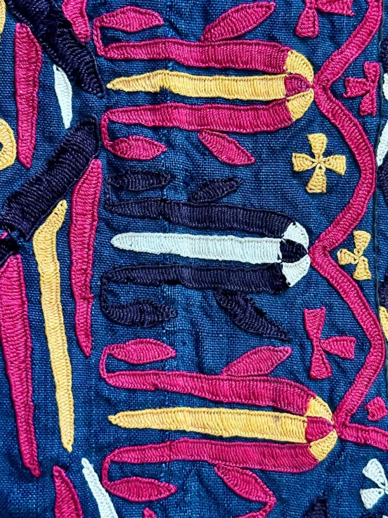 Persian satin stitch embroidery worked in silk thread on a blue fabric ground