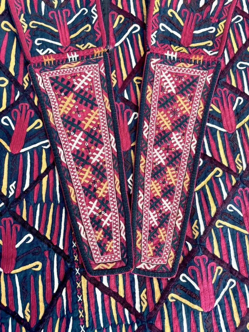 Close-up of silk kesdi embroidery forming stylized tulip motifs.