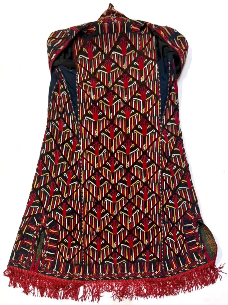 Back view of a Tekke Turkmen bridal robe showing dense tribal embroidery and decorative panels