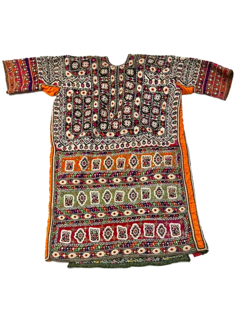 Back of a traditional Baluch embroidered dress showing geometric needlework and mirror embellishments.